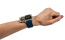 Load image into Gallery viewer, Hand wearing a futuristic digital watch on a white background