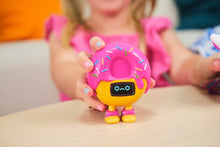 Load image into Gallery viewer, Toy figure with pink donut top and yellow body on a table, child in background