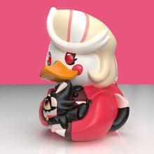 Load image into Gallery viewer, Close up view of Charlie Morningstar rubber duck figurine holding a black key with a helmet and backpack on a pink background