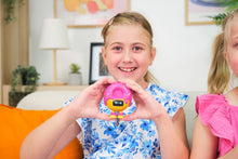 Load image into Gallery viewer, Two young girls holding a pink toy with a yellow character on a couch.
