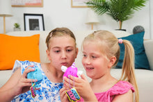 Load image into Gallery viewer, Two young girls playing with colorful toys on a couch.