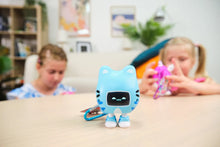 Load image into Gallery viewer, Blue robot toy on a table with children playing in the background