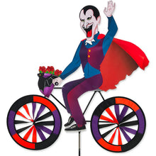 Load image into Gallery viewer, Side view of Premier Kites Colorful Dracula Whirlygig on a bicycle with spinning wheels.