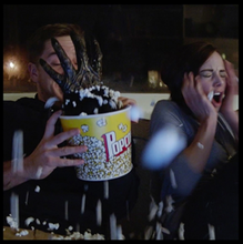Load image into Gallery viewer, Secret hand coming out of a bucket of popcorn, with another person reacting in the background.
