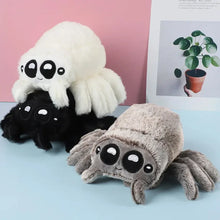 Load image into Gallery viewer, Three spider-shaped plush toys in black, white, and gray on a light blue surface with a pink wall and plant in the background.
