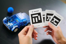 Load image into Gallery viewer, Hands holding playing cards with a 'burnout' logo next to a toy car on a dark surface
