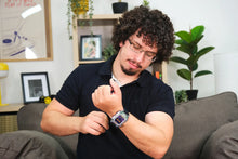 Load image into Gallery viewer, Man wearing a smartwatch in a living room setting
