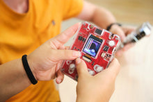 Load image into Gallery viewer, Person holding a red electronic device with visible circuitry
