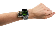 Load image into Gallery viewer, Person wearing a futuristic smartwatch on a white background
