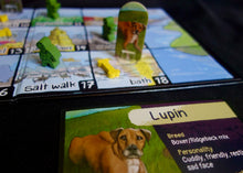 Load image into Gallery viewer, Close up of Good Dog, Bad Zombies Board game with dog-themed cards and pieces on a table
