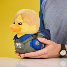 Load image into Gallery viewer, Resident Evil Leon Plush toy duck in R.P.D. uniform being held in two hands for size comparison with yellow background
