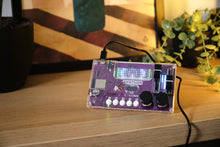 Load image into Gallery viewer, Purple electronic device with buttons and display on a wooden surface

