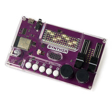 Load image into Gallery viewer, A purple Synthia electronic music module inside a clear plastic case, photographed at an angle on a white background.
