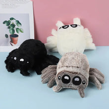 Load image into Gallery viewer, Three plush spider toys in black, gray, and white on a light blue surface with a pink background.
